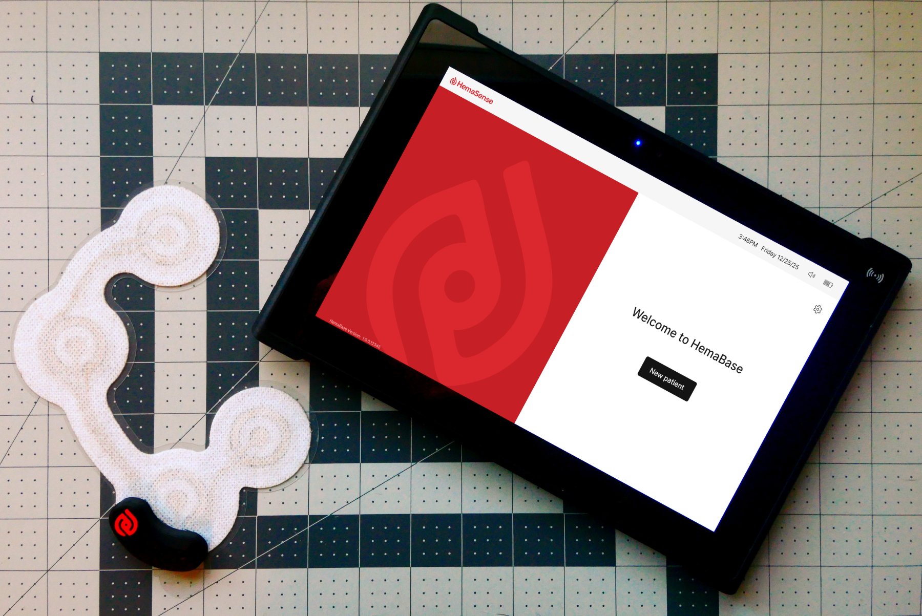 The HemaSense wearable patch and sensor beside the HemaBase bedside monitor.